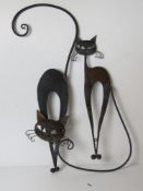 A pair black painted metal cat themed wall decorations.