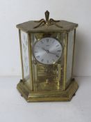 A brass and glass mantle clock by Kundo, approx 25cm high.