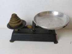 A pair of vintage balance weighing scales with set of brass graduated weights.