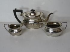 A silver plated tea set comprising teapot, sugar bowl and jug marked for H&CS.