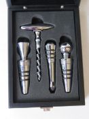A set of three wine stoppers with corkscrew in presentation box.