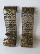 A pair of large contemporary wall mounting candle sconces.
