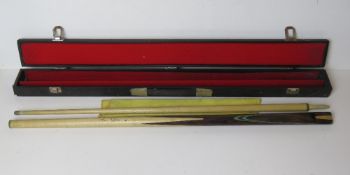 A Terry Griffiths snooker cue in case.