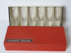 A boxed set of six tall shot glasses with solid spun bases within original box bearing label