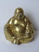 A brass Buddha sculpture standing 15cm high.