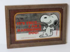 A late 20th century Snoopy mirror in wooden frame.