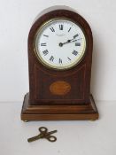 An inlaid mahogany Edwardian mantle clock having white enamel dial marked for JAS. J. Briggs Cromer.