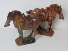 A pair of carved rouge marble Eurasian horse statues.