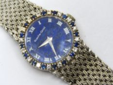 A 9ct white gold Bueche-Girod ladies wristwatch having sapphire and diamond bezel on integral white