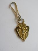A gold plated handbag tag marked for Gucci.