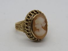 A carved shell cameo ring having heavy filigree mount, Coninental? hallmarks, size L, 7.9g.