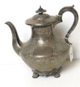 A large William IV HM silver teapot having floral engraving throughout and raised over four