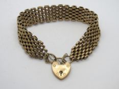 A vintage 9ct gold articulated link bracelet having heart padlock clasp,