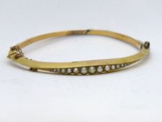 An antique bangle set with graduated split and seed pearls, a/f.