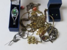 A quantity of assorted costume jewellery including bangle in box, chains, brooches, etc.