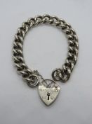 A heavy HM silver curb chain bracelet having large padlock heart clasp, hallmarked for London, 58.