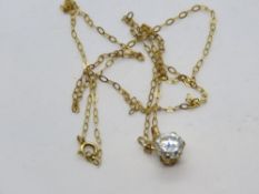 A white stone solitaire pendant on 9ct gold chain.