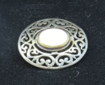 A silver Celtic style brooch having central mother of pearl panel, in presentation box.