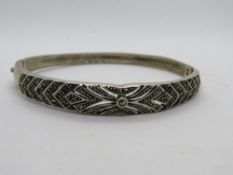 A contemporary 925 silver and marcasite hinged bangle in the Art Deco style.