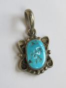A Native American style white metal and turquoise pendant, no apparent hallmarks, 2.5cm inc bale.