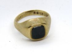 A 9ct gold bloodstone signet ring, uncarved, hallmarked 375, size H, 3.8g.