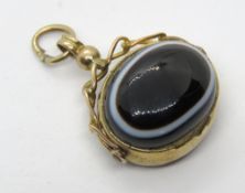 A 19th century 9ct gold and bulls eye agate spinning fob pendant having carnelian verso,