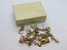 A 9ct gold charm bracelet with heart padlock clasp hallmarked 375 and thirteen charms upon (two no
