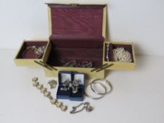 A vintage travel jewellery box opening to reveal silver and costume jewellery within including four
