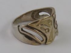 A silver ring having carved Aztec pattern upon, marks indistinct, size O.