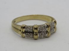 A 9ct gold ring having double band pattern with six segments each set with four diamonds,