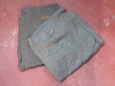 Two pairs of Cabela's trousers in green sizes 38 and 40.