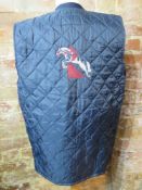 A men's horse riding gillet in navy blue with jockey embroidered design to back by Sam Rosa, size L.