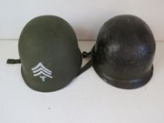 A US M1 helmet with liner, chin strap and sergeant stripes,