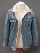 A 100% cotton denim jacket having floral