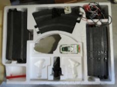 A Scalextric Team Jaguar race track in used condition having one car within.