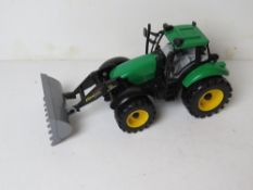 A children's toy farm digger, approx 28cnm in length.