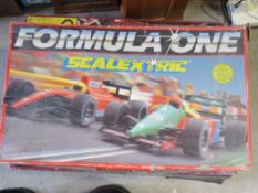A Scalextric Formula One race track, box a/f, having two cars and two controllers within.