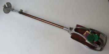 A vintage shooting stick having various