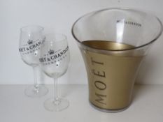 A Moet & Chandon champagne cooler with p