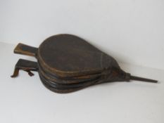 A large pair of wooden and leather fire