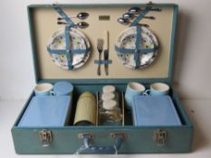 A Brexton picnic basket containing cups,