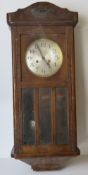 An oak cased hanging wall clock having s