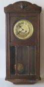 An oak cased hanging wall clock having b