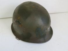 A US M1 Vietnam helmet with liner and ch