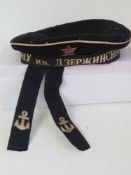 A Soviet Navy hat having ships ribbon, l