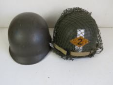 Two US M1 helmets, one with liner, one h