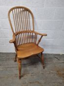 A contemporary pine high backed carver chair measuring approx. 111cm to back.