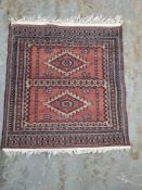 A prayer rug in reds and blues approx. 66 x 63cm.