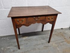A low boy style occasional table having central drawer flanked by twin box drawers with brass drop