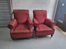 A pair of armchairs in burgundy and gold fabric having turned legs with castors to front,